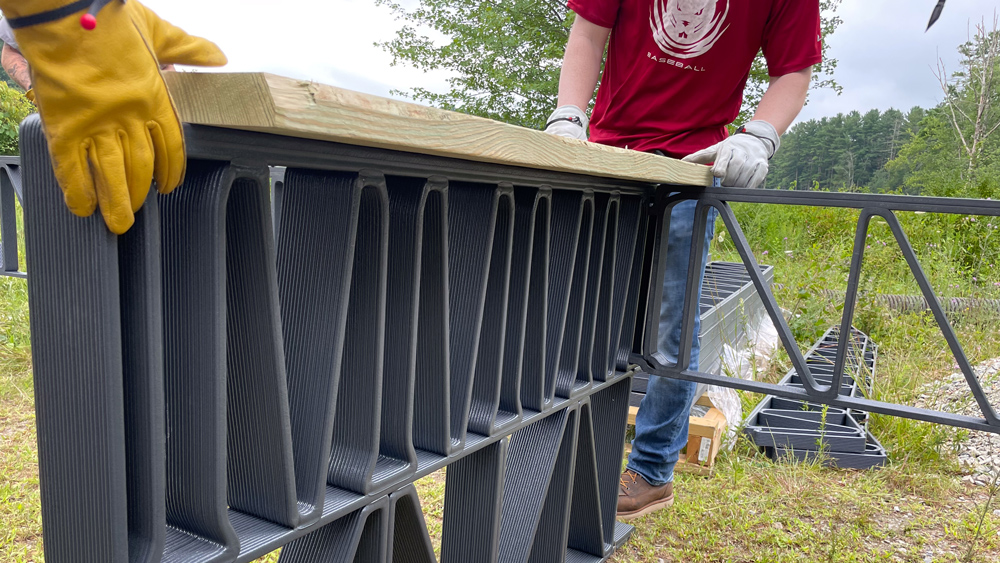 3D-printed trusses being installed in a wetland