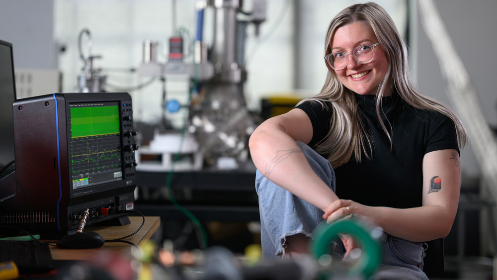 Lainey McKinney in lab with oscilloscope